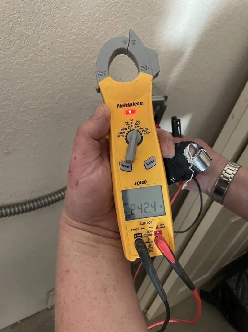 Voltage testing with clamp meter during Recessed Lighting Installation in Irving
